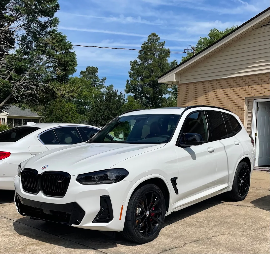 White BMW X3 with tinted windows in a driveway