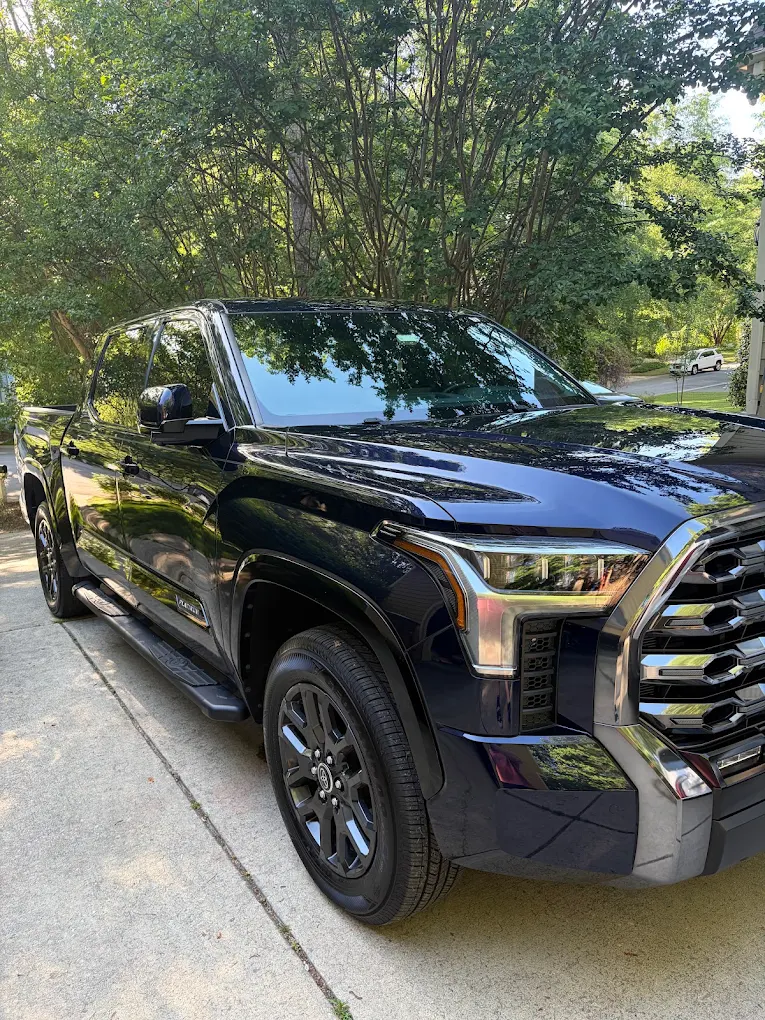 Black Toyota Tundra with tinted windows in a driveway