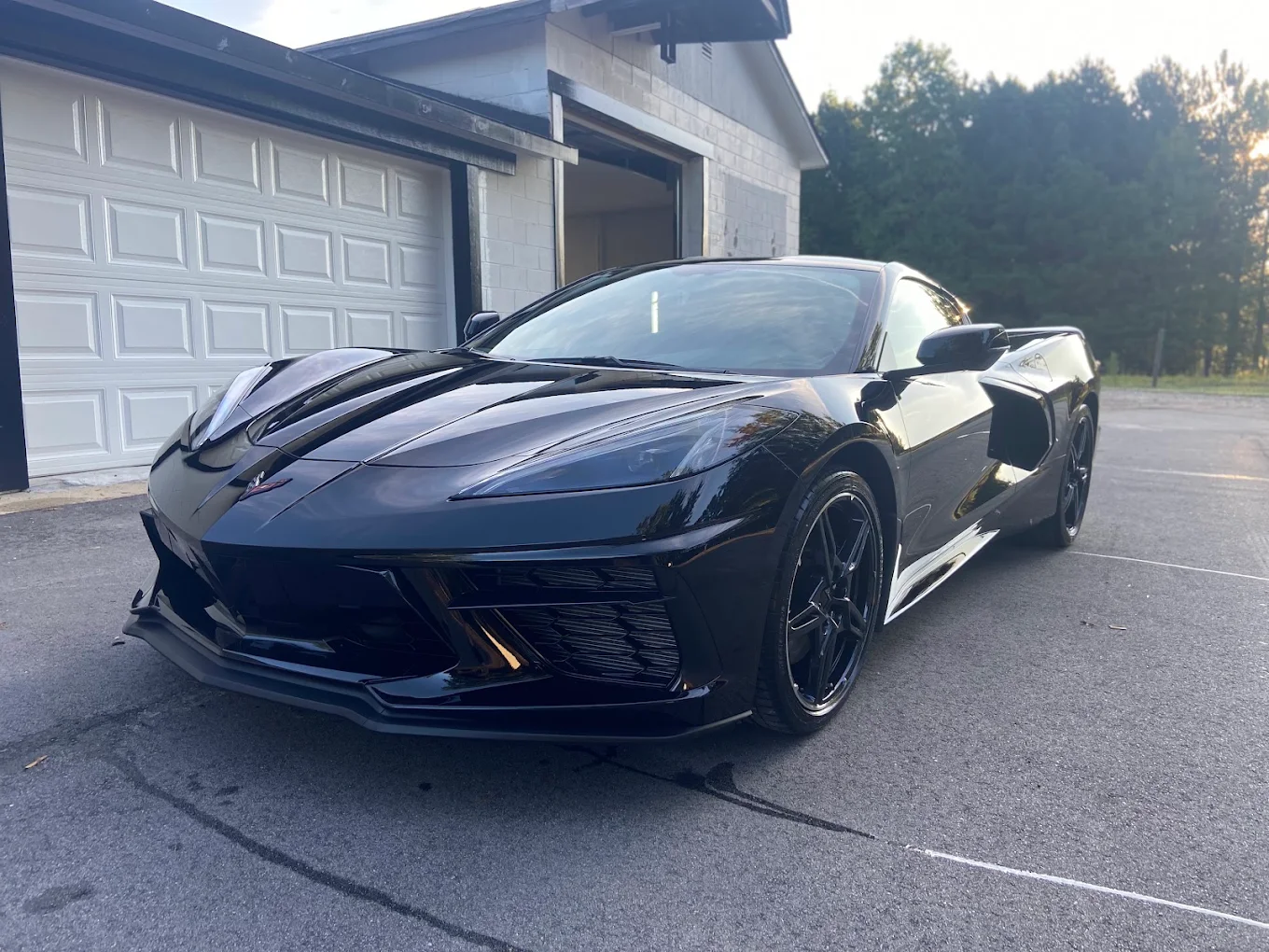 Black Chevrolet Corvette with tinted windows outside the WashNWerk shop